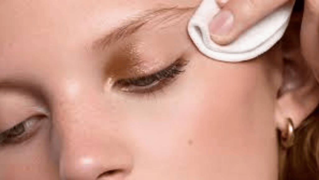 applying eye makeup remover